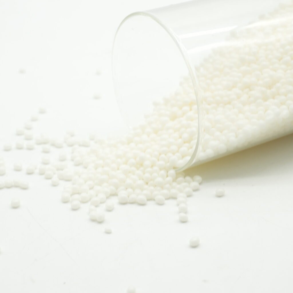Glue for Edge Banding EVA hot‑melt pellets pouring out from transparent plastic container