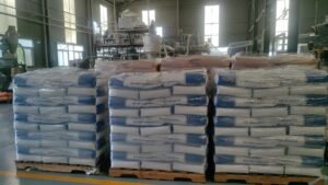 Factory warehouse storage of packaged hot melt adhesive, hot glue pellets stacked on wooden pallets