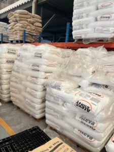 Pallet stock of hot melt adhesive raw material bags inside factory warehouse
