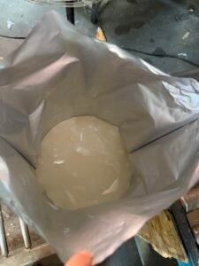 Liquid PUR hot melt adhesive raw material in bulk container at temperature-controlled storage facility